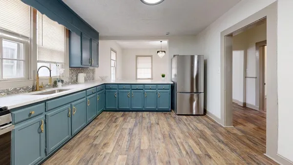 a kitchen with stainless steel appliances granite countertop a refrigerator and a sink
