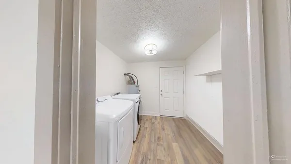 a view of a room with wooden floor