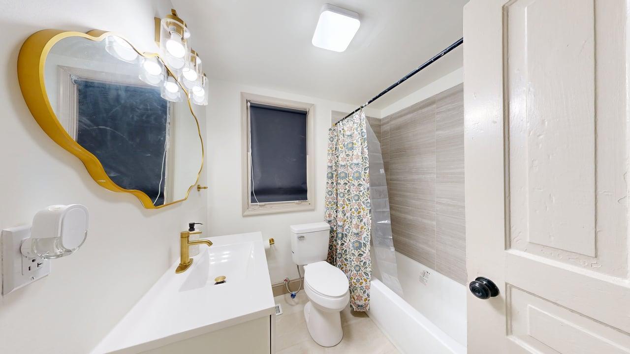 860 Stokes Street Danville, VA 24541 - Photo 9 of 32 a bathroom with a sink toilet and shower