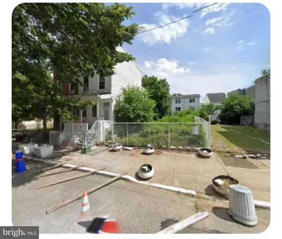 a backyard of a house with barbeque oven table and chairs