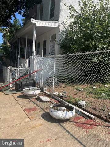a view of a patio with table and chairs and potted plants