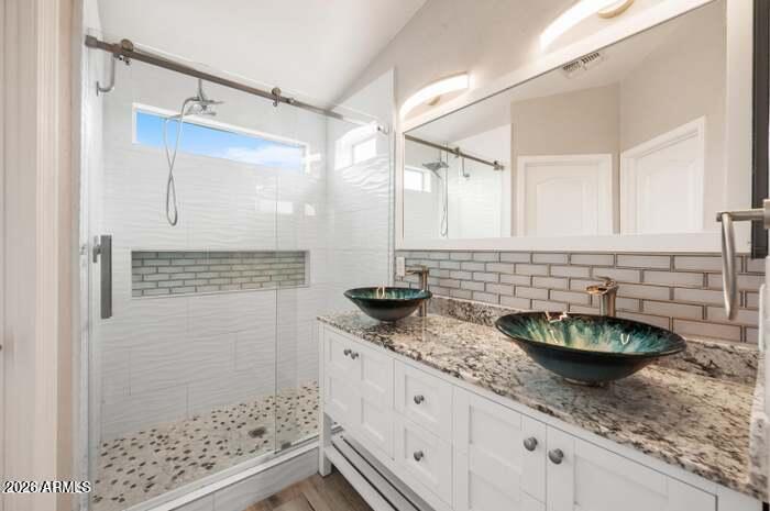 4130 East Chambers Street Phoenix, AZ 85040 - Photo 11 of 21 a bathroom with a granite countertop sink a mirror and shower