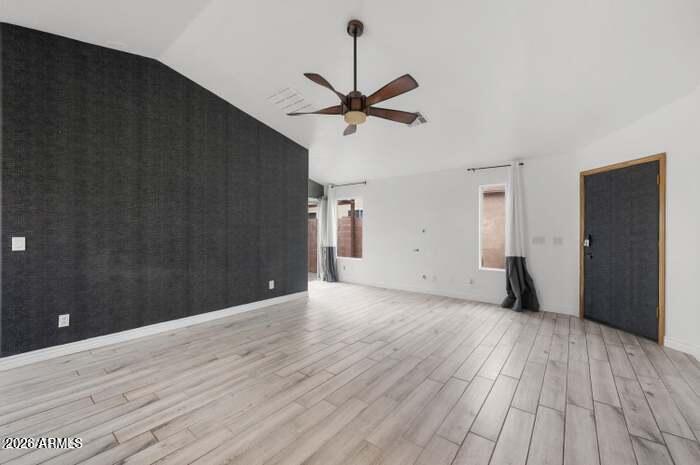 4130 East Chambers Street Phoenix, AZ 85040 - Photo 3 of 21 a view of a livingroom with a ceiling fan and wooden floor