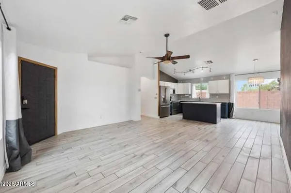 a view of a livingroom with furniture and a ceiling fan
