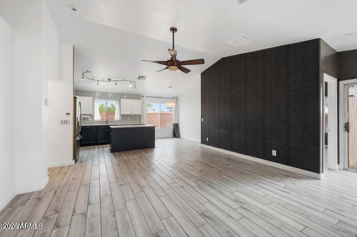 4130 East Chambers Street Phoenix, AZ 85040 - Photo 5 of 21 a view of a kitchen with wooden floor and a sink