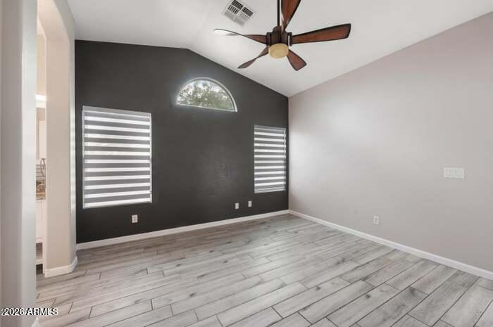 4130 East Chambers Street Phoenix, AZ 85040 - Photo 10 of 21 an empty room with wooden floor and windows