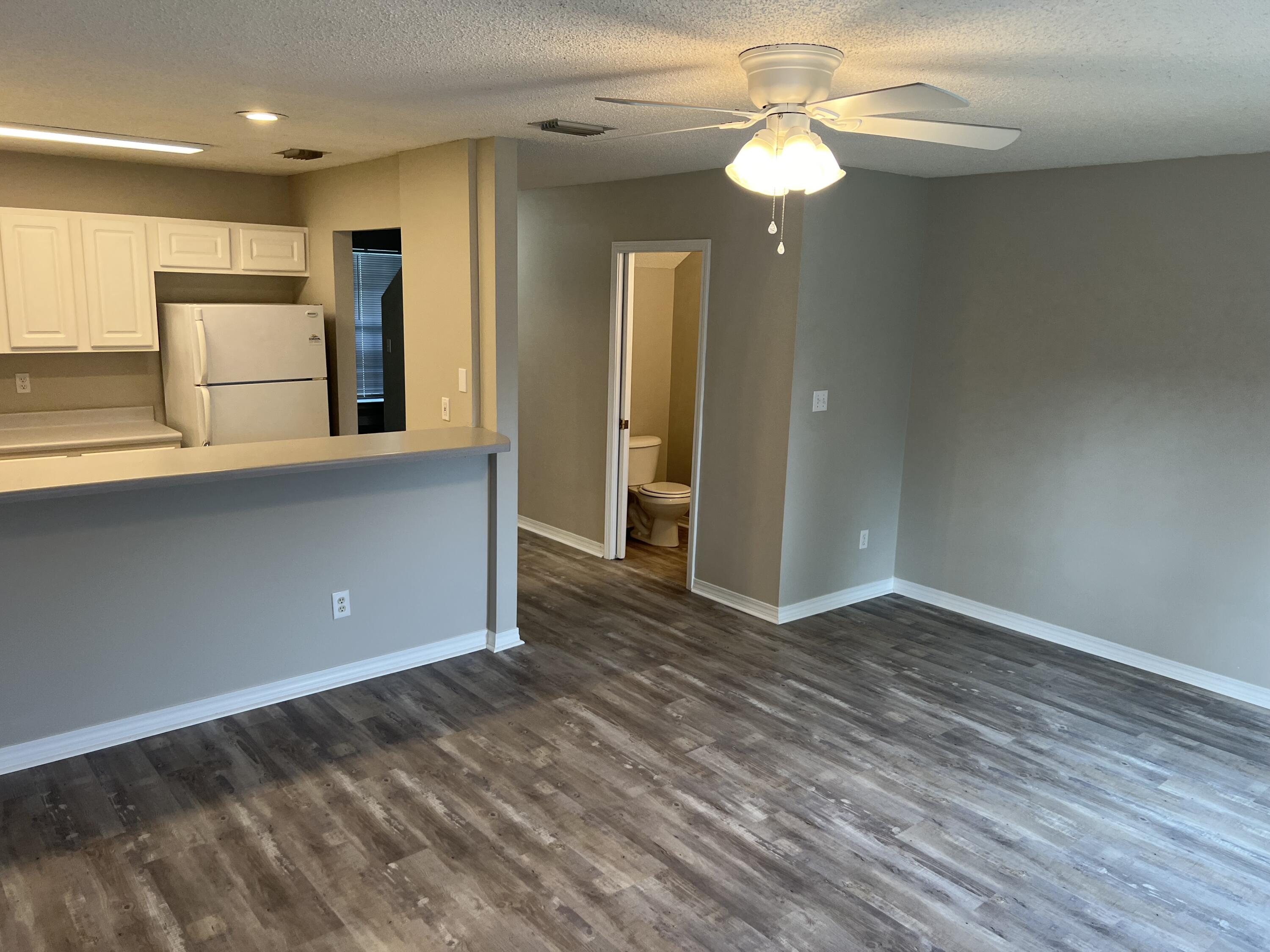 2263 Whitman Lane Fort Walton Beach, FL 32547 - Photo 4 of 7 a view of empty room with wooden floor and window