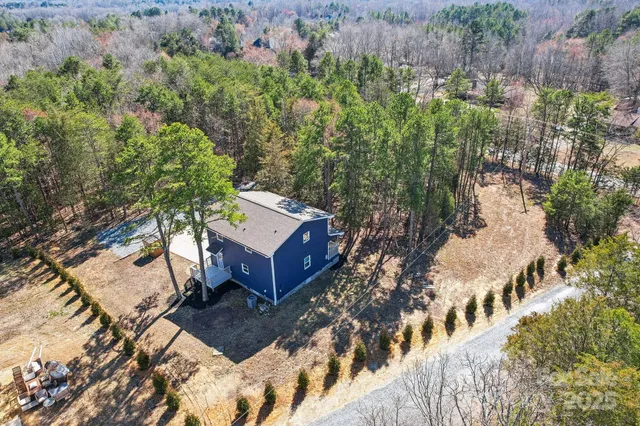 a view of a house with a yard and sitting area