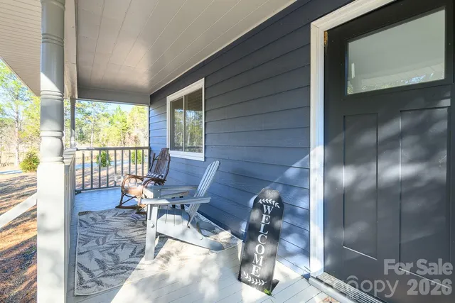 a living room filled with furniture hardwood floor and a floor to ceiling window