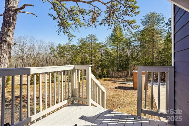 a view of balcony with wooden floor and fence