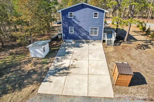 a wooden bench sitting in front of a house