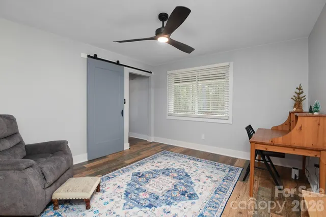 a bedroom with a bed and a chair