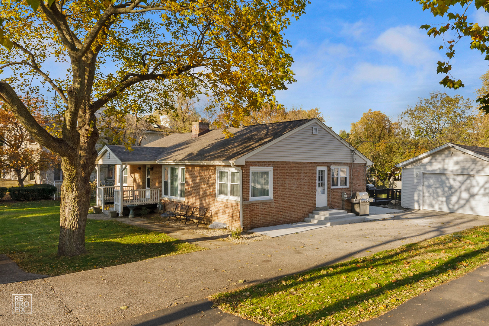 310 West Rand Road Mount Prospect, IL 60056 - Photo 1 of 26 a front view of a house with a yard and trees