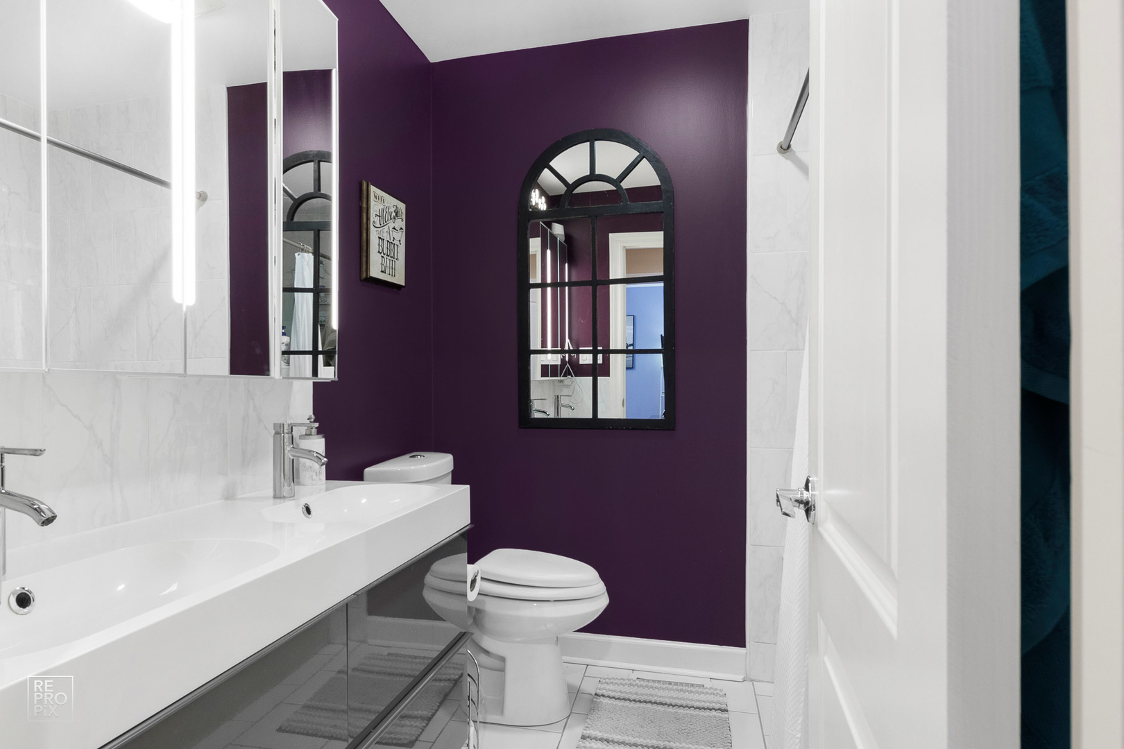 310 West Rand Road Mount Prospect, IL 60056 - Photo 13 of 26 a bathroom with a toilet a sink and mirror