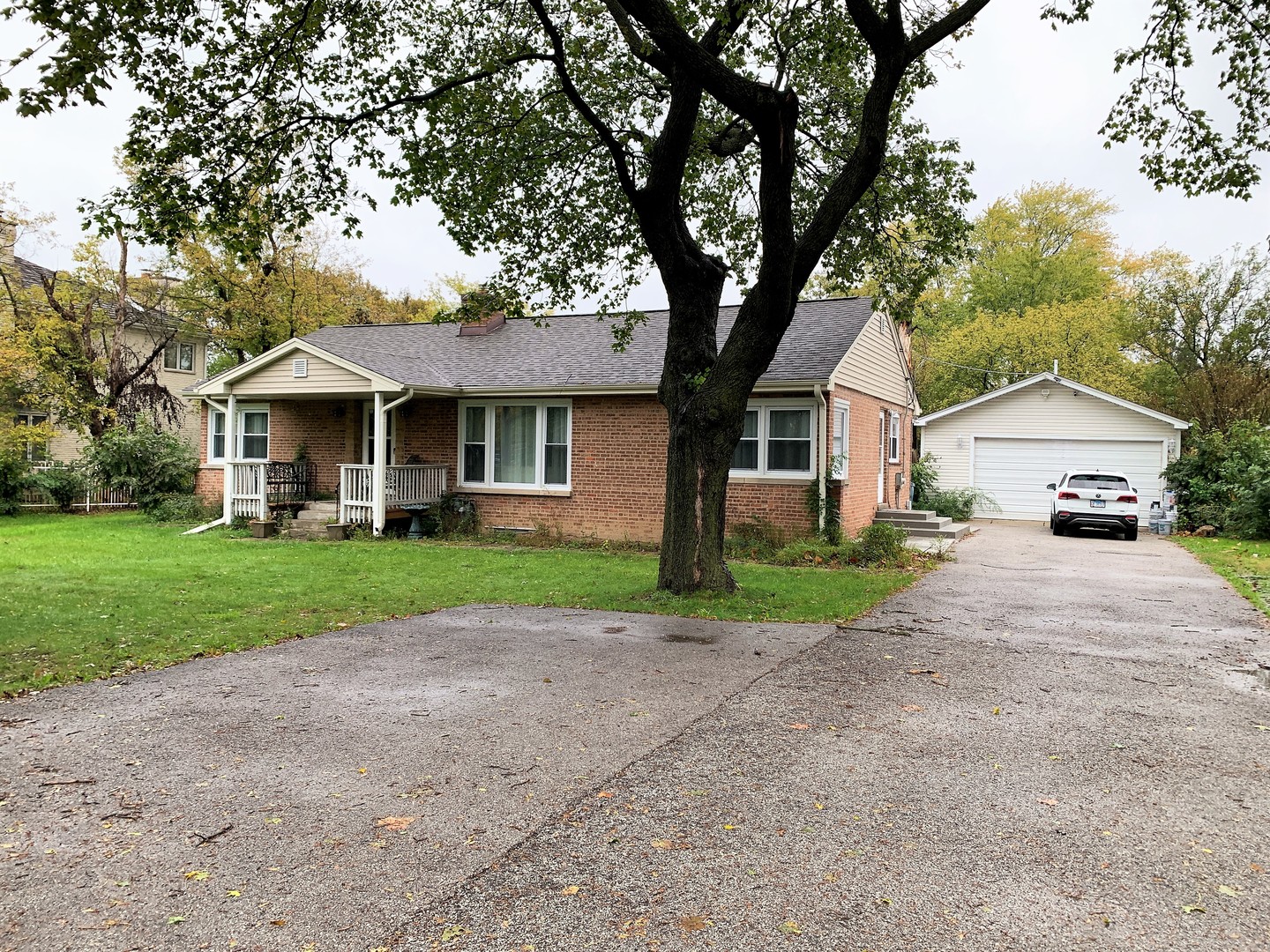 310 West Rand Road Mount Prospect, IL 60056 - Photo 22 of 26 a front view of a house with a yard and large trees