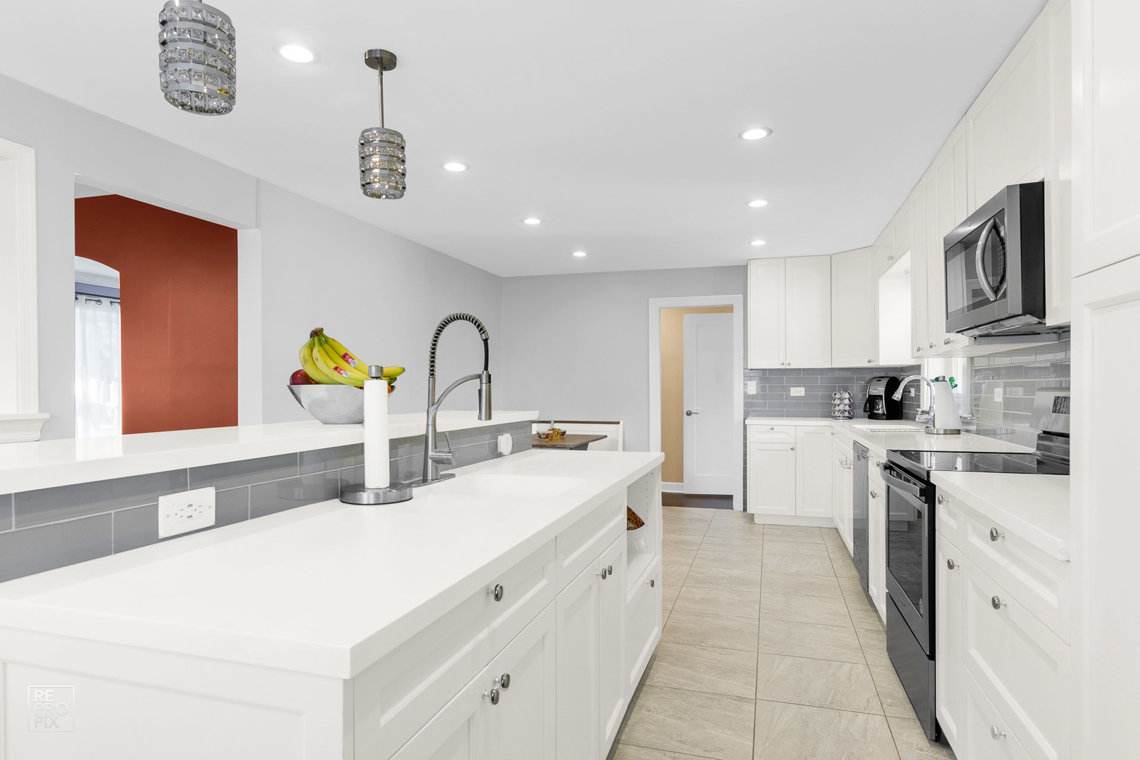 310 West Rand Road Mount Prospect, IL 60056 - Photo 7 of 26 a kitchen with stainless steel appliances granite countertop a sink and dishwasher a stove top oven with wooden floor