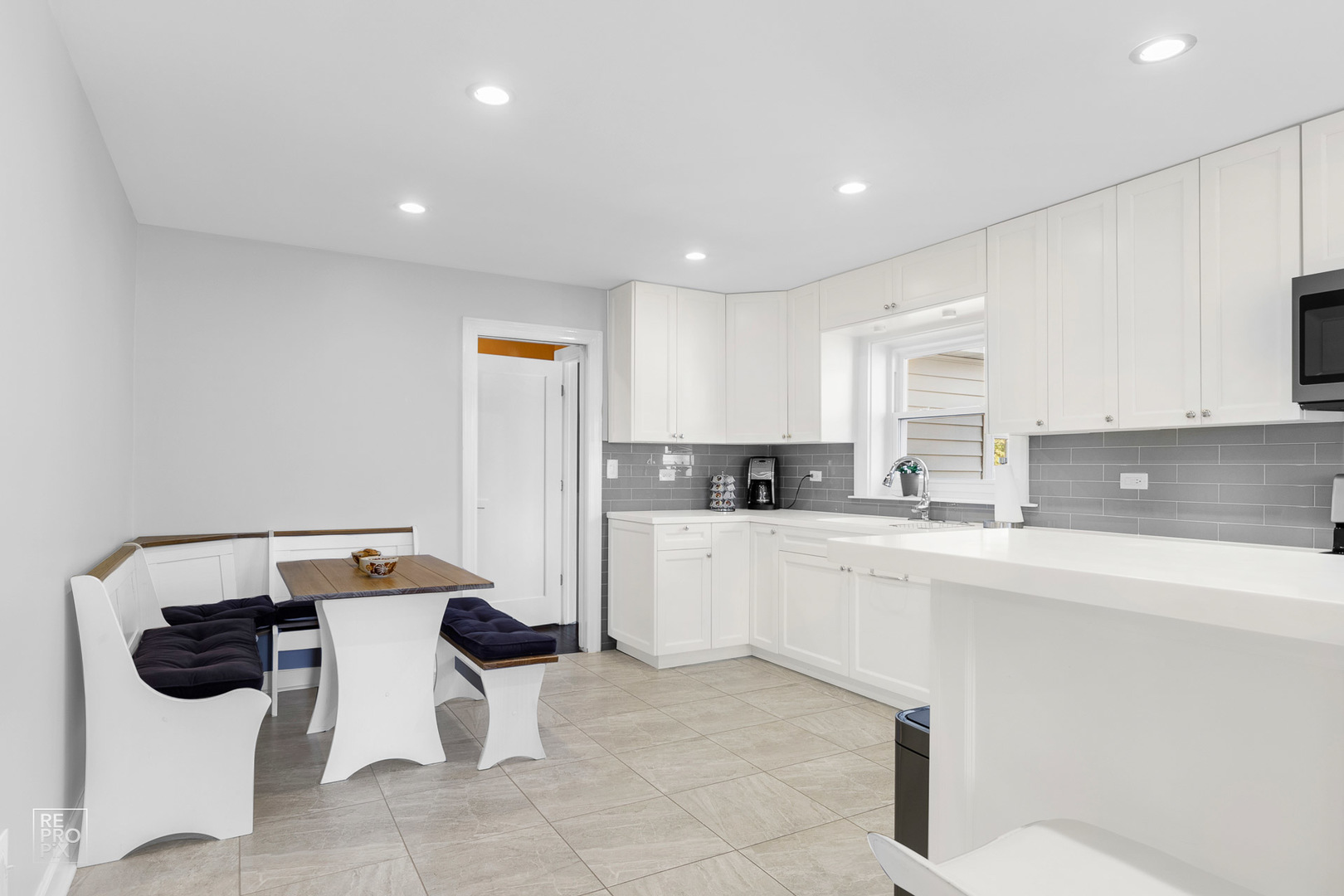 310 West Rand Road Mount Prospect, IL 60056 - Photo 8 of 26 a kitchen with a sink and white cabinets