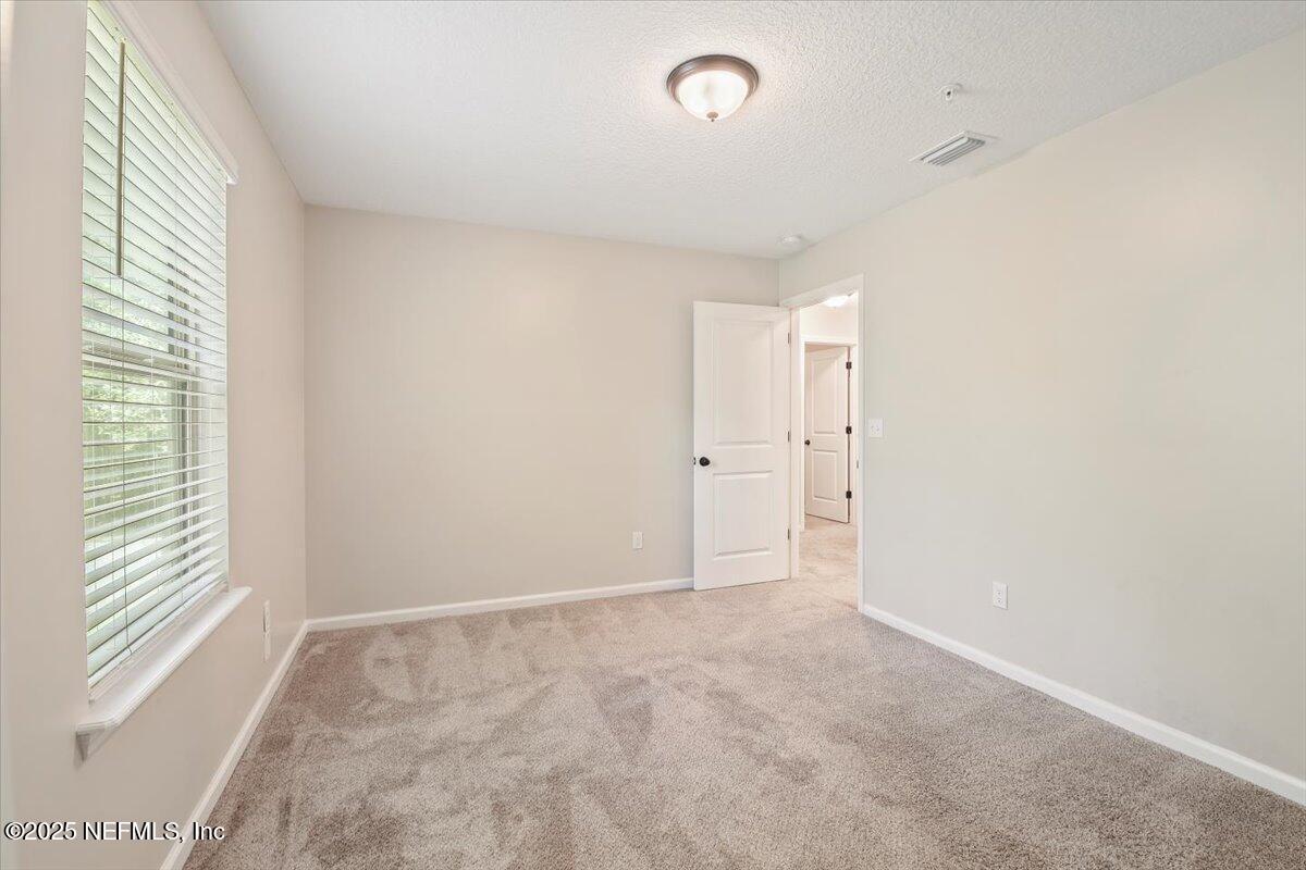 4182 Quiet Crk Loop Middleburg, FL 32068 - Photo 19 of 30 an empty room with windows