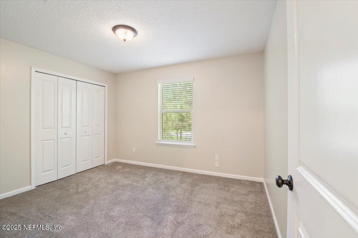4182 Quiet Crk Loop Middleburg, FL 32068 - Photo 20 of 30 a view of an empty room with a window