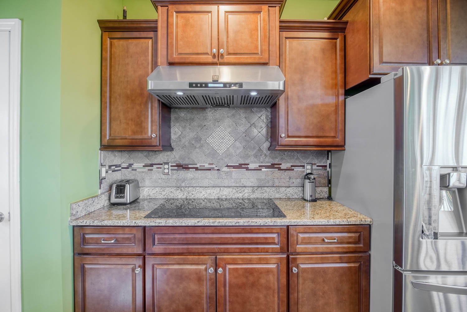 5088 Franklin Road Lebanon, TN 37090 - Photo 22 of 44 a kitchen with granite countertop a refrigerator and a stove top oven