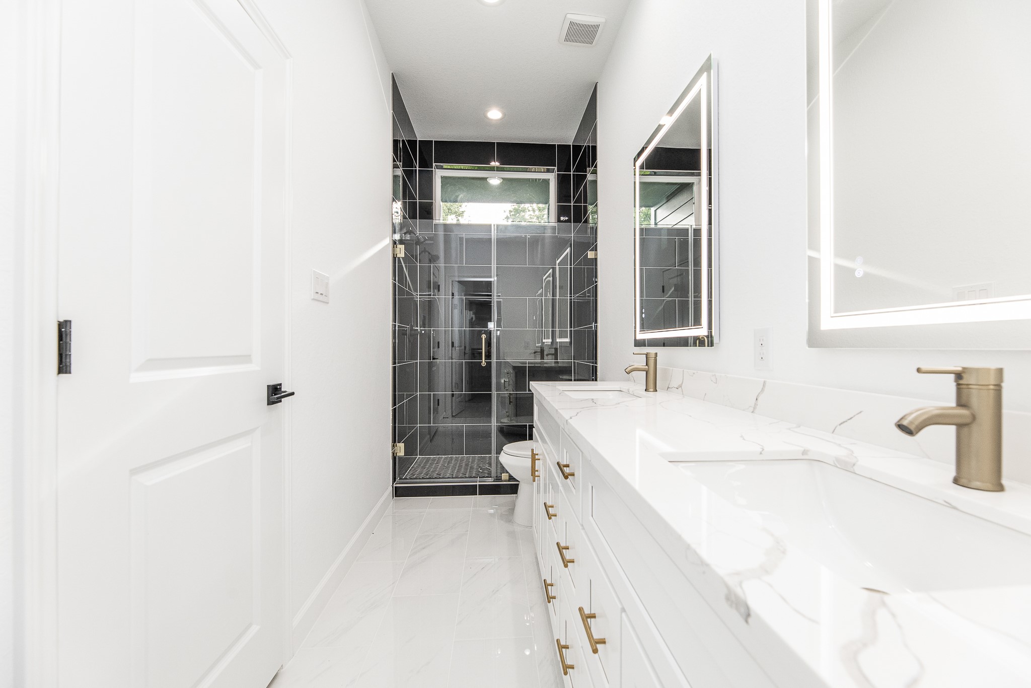 8502 Safeguard Street, Unit B Houston, TX 77051 - Photo 19 of 26 a bathroom with a sink a mirror and a shower