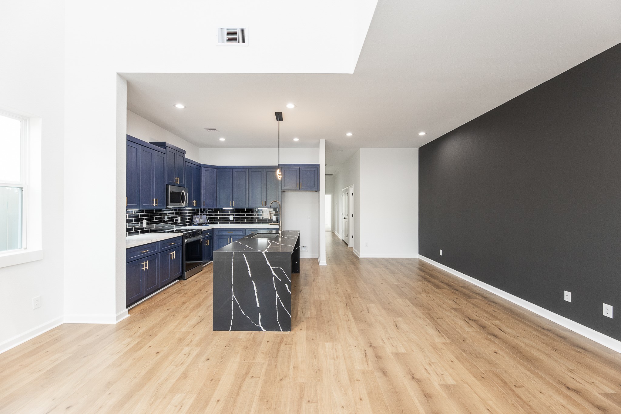 8502 Safeguard Street, Unit B Houston, TX 77051 - Photo 5 of 26 a kitchen with granite countertop a sink a counter top space stainless steel appliances and cabinets