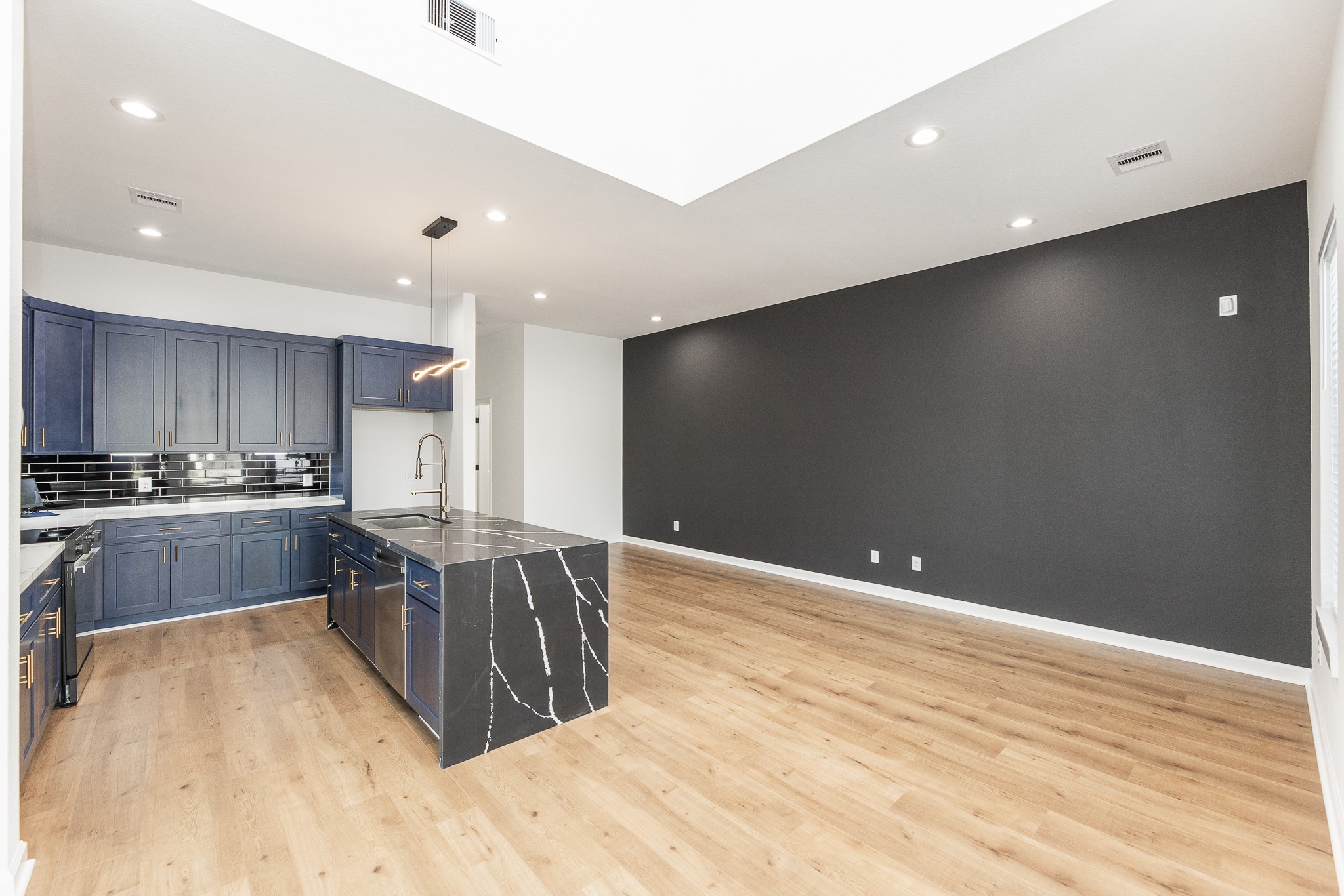 8502 Safeguard Street, Unit B Houston, TX 77051 - Photo 6 of 26 a kitchen with stainless steel appliances a refrigerator and a wooden floor