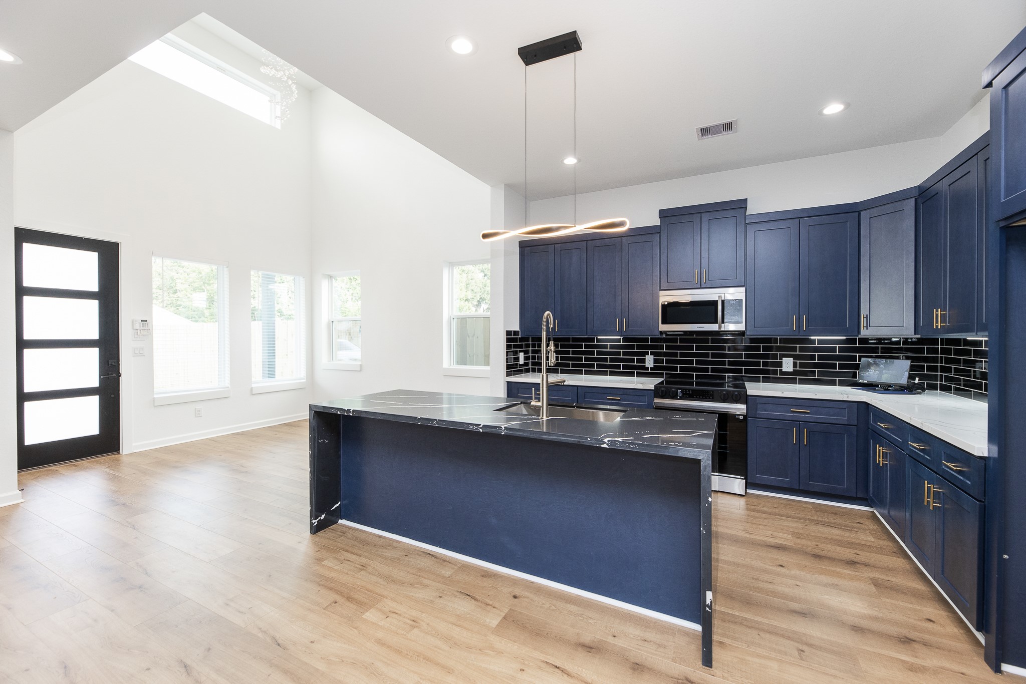 8502 Safeguard Street, Unit B Houston, TX 77051 - Photo 9 of 26 a kitchen with stainless steel appliances granite countertop a sink a stove and wooden floors