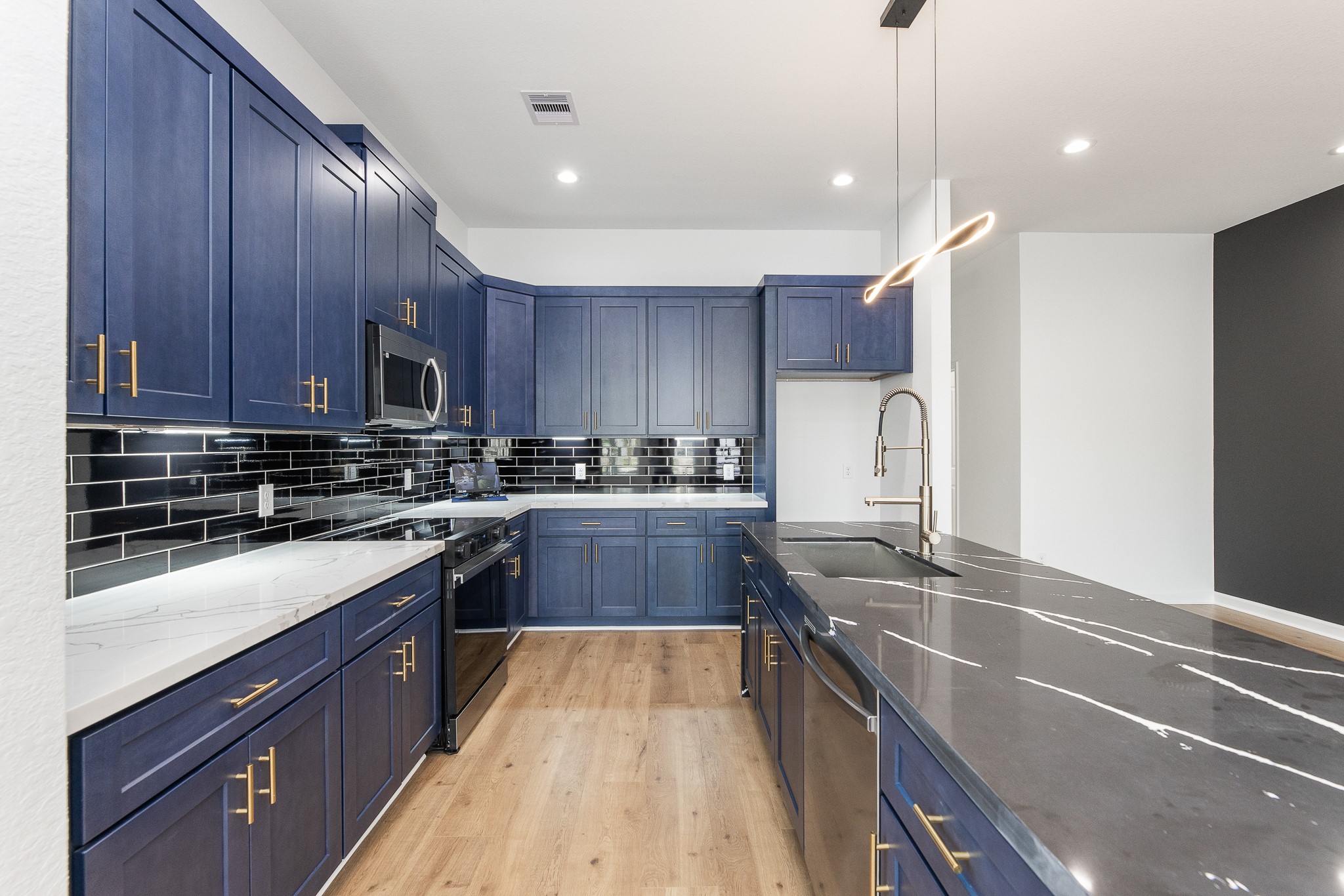 8502 Safeguard Street, Unit B Houston, TX 77051 - Photo 10 of 26 a kitchen with stainless steel appliances granite countertop a sink a stove and a refrigerator