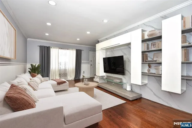 a living room with furniture flat screen tv and large window