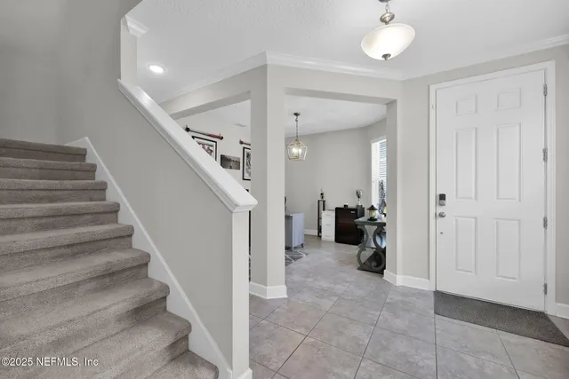 a bedroom with a bed and paintings on the wall