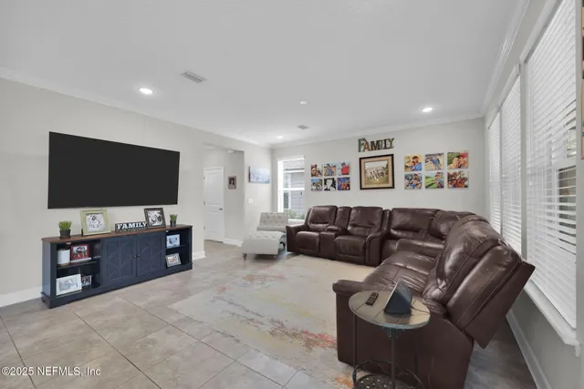 a kitchen with stainless steel appliances granite countertop a stove a refrigerator and a wooden floor