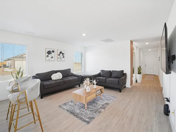 a living room with furniture and a rug