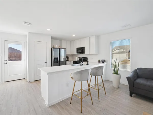 a kitchen with stainless steel appliances a refrigerator and a stove top oven