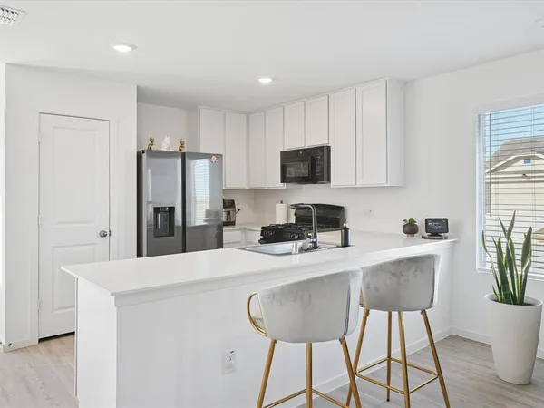 a kitchen with stainless steel appliances a microwave sink and refrigerator