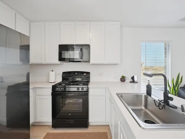 a kitchen with a sink and a stove top oven