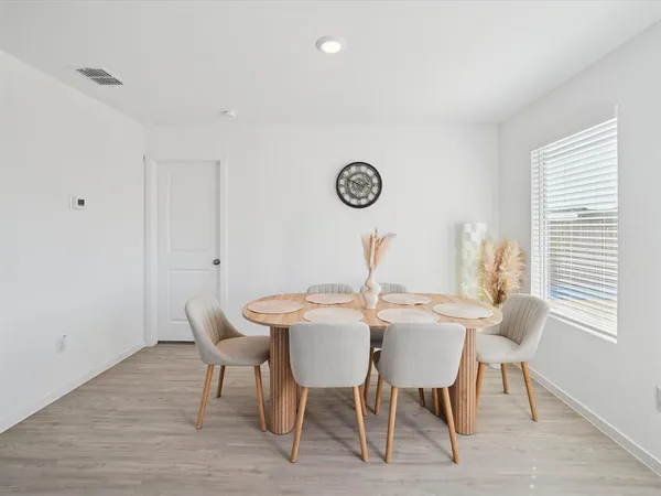 a view of a dining room with furniture and window