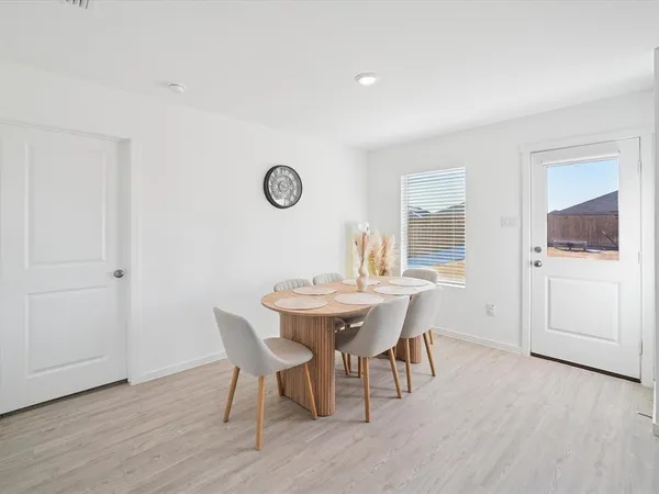 a dining room with furniture and window