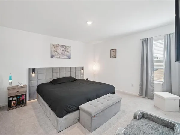 a bedroom with a bed and a couch