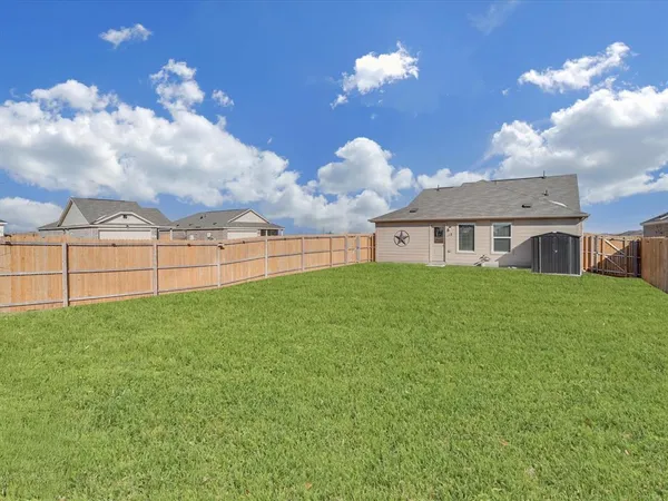 a view of a house with a backyard
