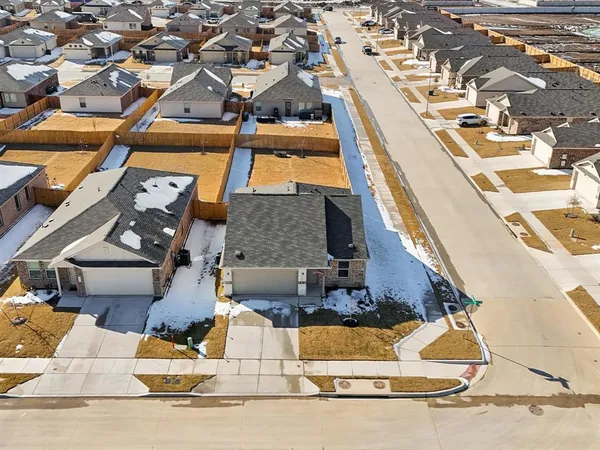 an aerial view of residential houses with yard