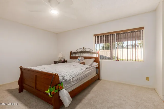 a bedroom with a bed and a window