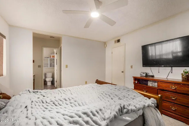 a bedroom with a bed and a flat screen tv