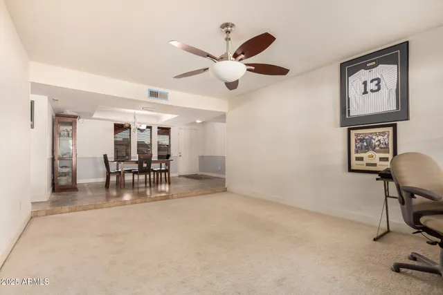 a dining room with furniture and a chandelier