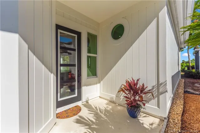 a view of a hallway to a house with wooden floor and stairs