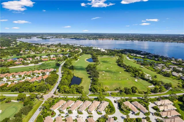 an aerial view of residential houses with outdoor space and street view