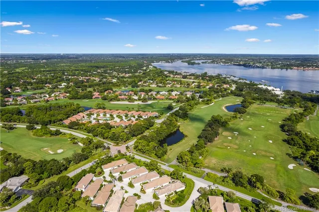 an aerial view of residential houses with outdoor space and street view