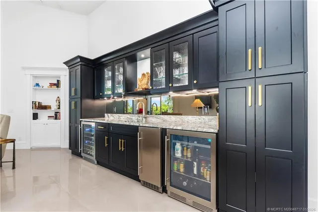 a kitchen with granite countertop a refrigerator and stove