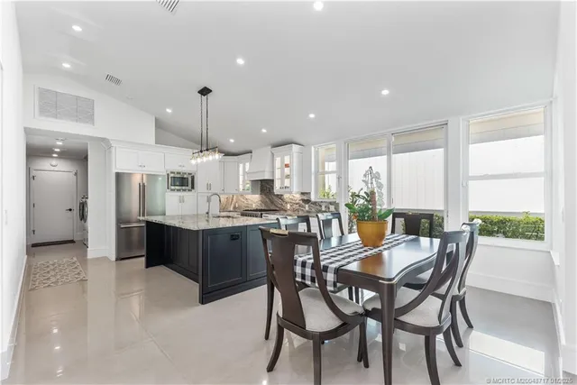 a large kitchen with a table and chairs