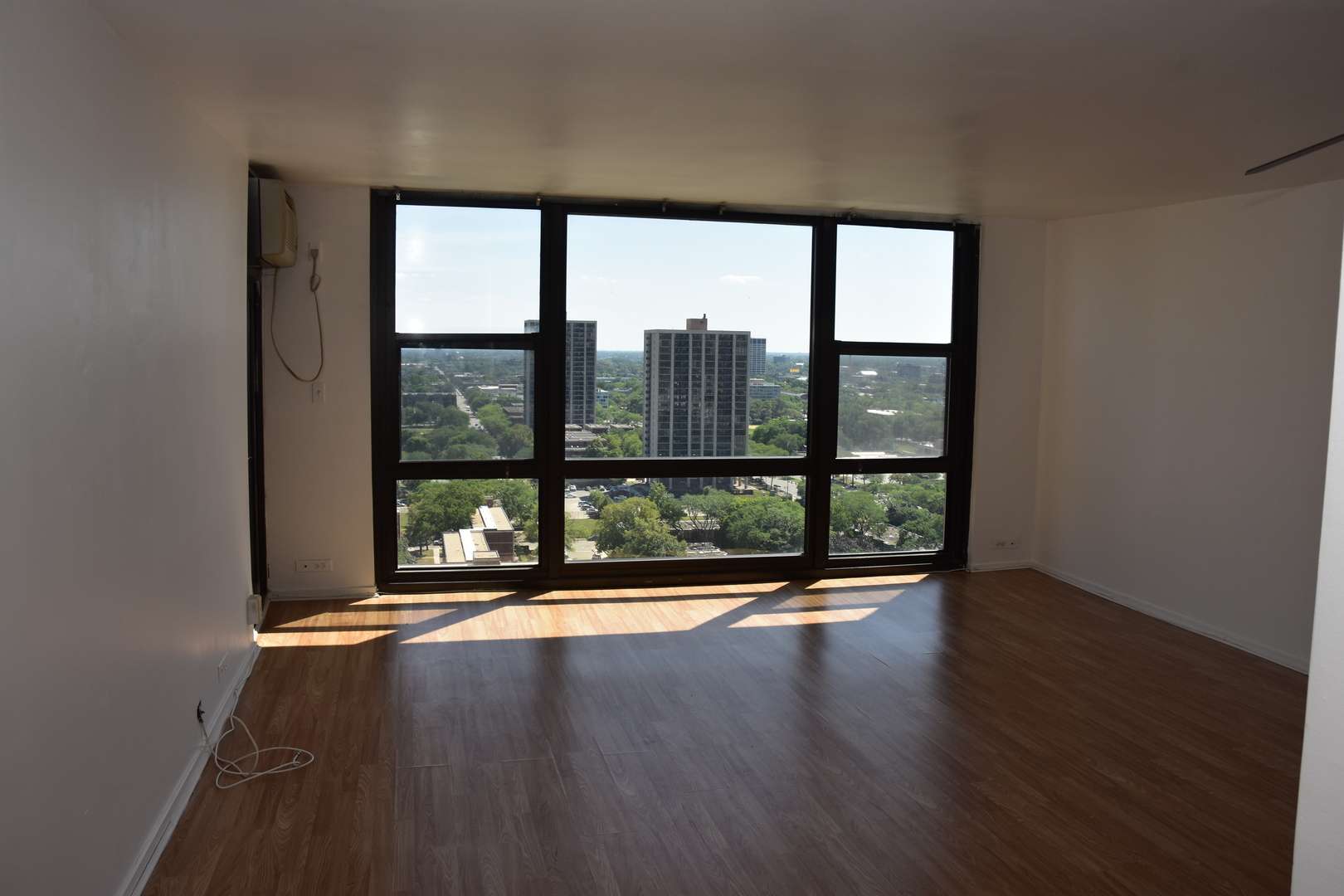 2605 South Indiana Avenue, Unit 2008 Chicago, IL 60616 - Photo 4 of 25 a view of wooden floor and windows in a room